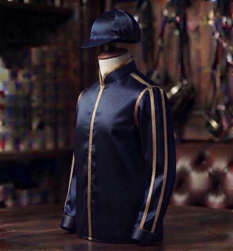 Chronos Thoroughbreds racing colours: dark blue jacket and sleeves with beige seams, dark blue cap